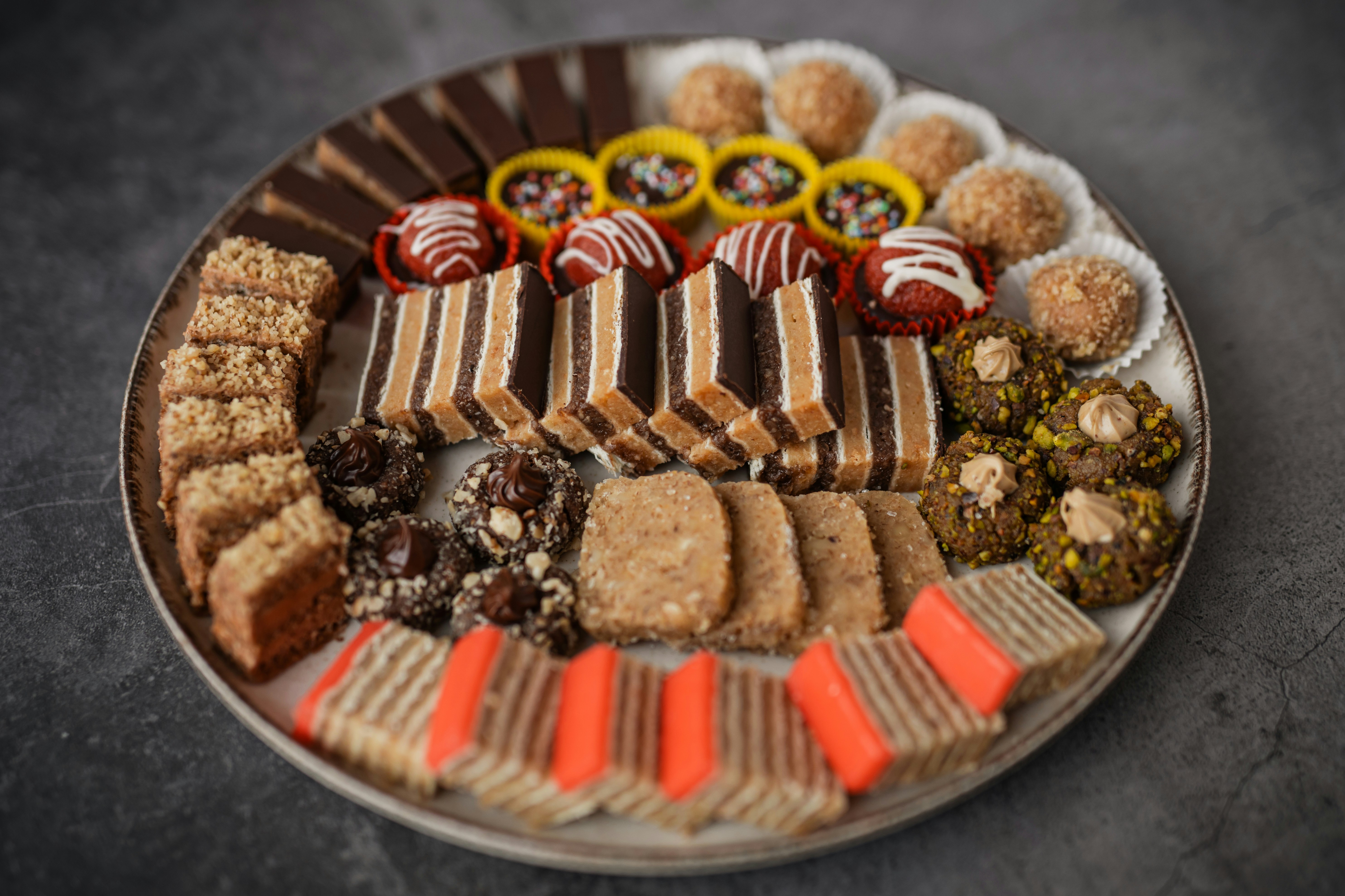 A platter of assorted sweet pastries and chocolates.